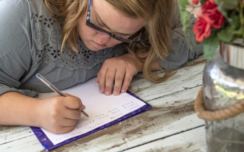 a girl writes a letter 