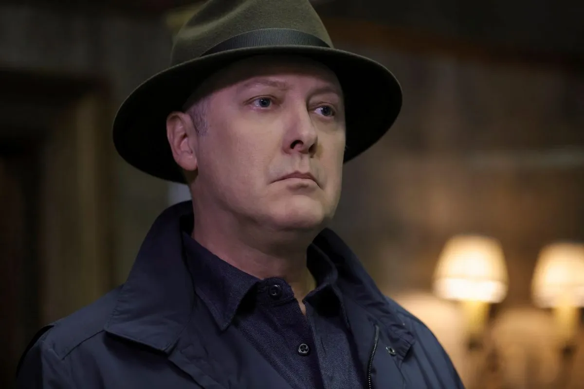 'The Blacklist' Season 9, which isn't new tonight, Dec. 16, stars James Spader as Raymond 'Red' Reddington. In the photo, Spader, as Red, wears a black coat over a black button-up shirt and a brown fedora.
